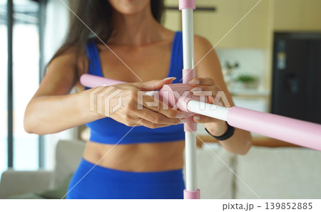 Woman blue sportswear adjusting physiotherapy device to correct his posture 139852885
