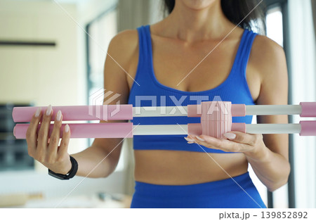 Woman blue sportswear adjusting physiotherapy device to correct his posture Woman blue sportswear adjusting physiotherapy device to correct his posture 139852892