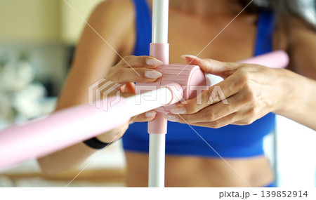 Woman blue sportswear adjusting physiotherapy device to correct his posture Woman blue sportswear adjusting physiotherapy device to correct his posture 139852914
