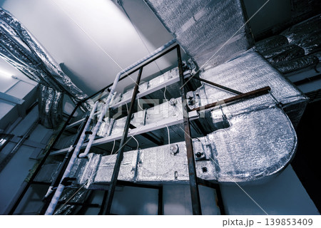 Ventilation pipe system indoors. Modern Industrial background. Ventilation pipe system indoors. Modern Industrial background. 139853409