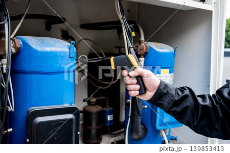 Technician use infrared thermal imaging camera to check temperature at fuse-box Technician use infrared thermal imaging camera to check temperature at fuse-box 139853413