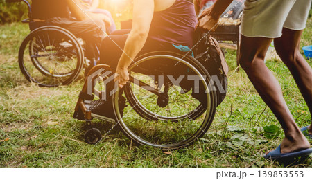 Disabled man resting in a campsite with friends. Wheelchair in the forest 139853553
