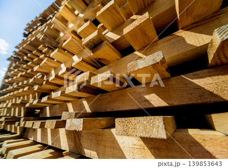 Stack of natural rough wooden boards. Wooden boards, lumber, industrial wood. 139853643