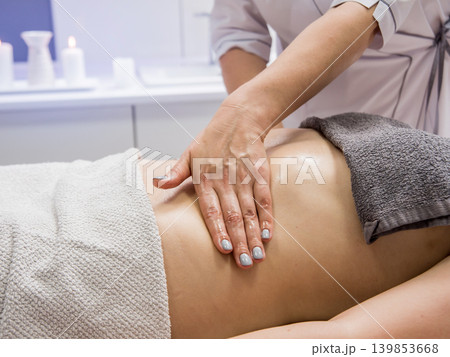 Beautiful young woman enjoying massage in spa salon. Cosmetology Beautiful young woman enjoying massage in spa salon. Cosmetology 139853668