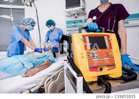 Doctors give resuscitation to a male patient in the emergency room. Doctors give resuscitation to a male patient in the emergency room. 139853835