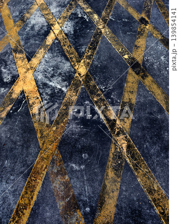 Navy textured surface crossed by gold diagonal lines, grainy indigo ground with speckled paint. 139854141