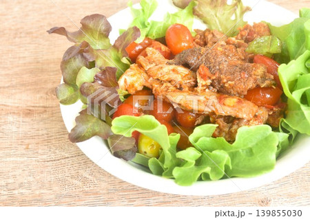 spicy fried roasted duck meat with tomato in curry and red oak salad on bowl spicy fried roasted duck meat with tomato in curry and red oak salad on bowl 139855030