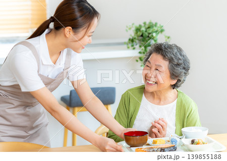食事の準備をするヘルパーとシニア女性 139855188
