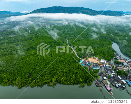 Aerial view top view of the fisherman village with fishing boats and house roof at the pier in Phang Nga Thailand Aerial view top view of the fisherman village with fishing boats and house roof at the pier in Phang Nga Thailand 139855241