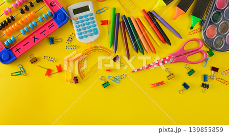 Colorful School Supplies and Stationery Items Scattered on Bright Yellow Background, Flat Lay Composition with Copy Space Colorful School Supplies and Stationery Items Scattered on Bright Yellow Background, Flat Lay Composition with Copy Space 139855859