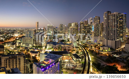 Railroad and public train line through downtown Miami in Florida, USA. Essential transport infrastructure in a city of modern high-rises at night 139856650