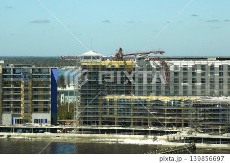 Aerial view of ruined by hurricane Ian construction crane on high apartment building site in Port Charlotte, USA Aerial view of ruined by hurricane Ian construction crane on high apartment building site in Port Charlotte, USA 139856697