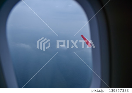 Looking from the airplane window with stunning skyscapes and landscape with airplane wing. Travel and transportation concept. Looking from the airplane window with stunning skyscapes and landscape with airplane wing. Travel and transportation concept. 139857388