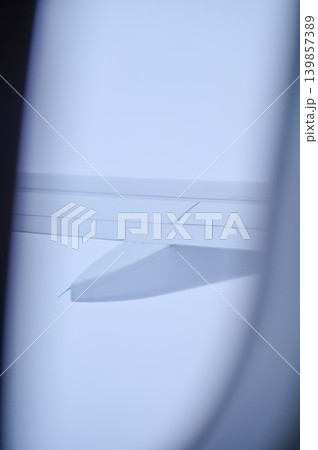 Looking from the airplane window with stunning skyscapes and landscape with airplane wing. Travel and transportation concept. Looking from the airplane window with stunning skyscapes and landscape with airplane wing. Travel and transportation concept. 139857389