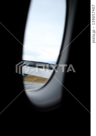 Looking from the airplane window with stunning skyscapes and landscape with airplane wing. Travel and transportation concept. Looking from the airplane window with stunning skyscapes and landscape with airplane wing. Travel and transportation concept. 139857407