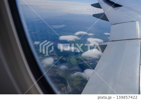 Looking from the airplane window with stunning skyscapes and landscape with airplane wing. Travel and transportation concept. 139857422