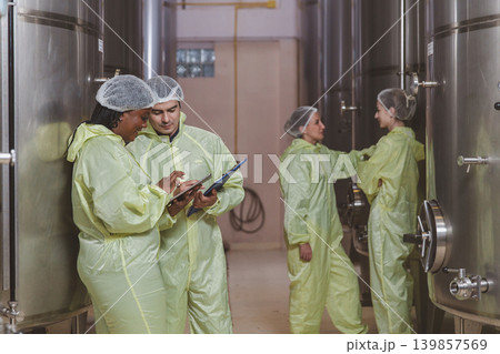 Winemaker working in modern large winery factory liquor drink industry quality. Winemaker working in modern large winery factory liquor drink industry quality. 139857569