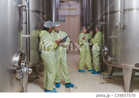 Winemaker working in modern large winery factory liquor drink industry quality. Winemaker working in modern large winery factory liquor drink industry quality. 139857570
