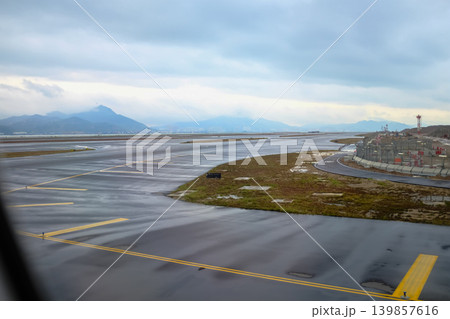 Looking from the airplane window of the landing scene. The scene of the airport apron. Travel and transportation concept. 139857616