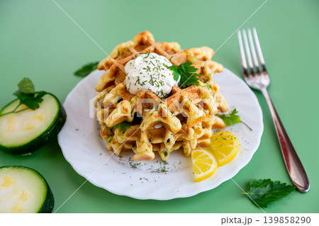 homemade savory waffles with zucchini herbs and sour cream topping homemade savory waffles with zucchini herbs and sour cream topping 139858290