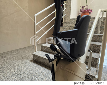 A wheelchair for stair climbing in the entryway of a modern home. The concept is inclusive and enhances ease of use within the home. A wheelchair for stair climbing in the entryway of a modern home. The concept is inclusive and enhances ease of use within the home. 139859043