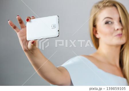 Happy woman taking selfie Happy woman taking selfie 139859105