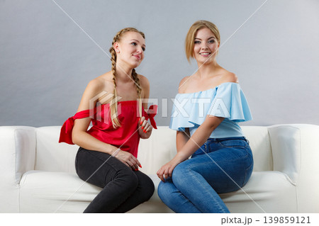 Two women talking together Two women talking together 139859121