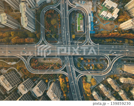 An aerial scene capturing traffic movement on a complex elevated highway and its connecting ramps in China during autumn season An aerial scene capturing traffic movement on a complex elevated highway and its connecting ramps in China during autumn season 139859230