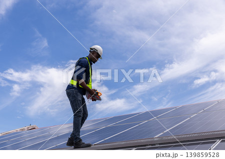 Engineer service check installation solar cell on the roof of factory. Engineer service check installation solar cell on the roof of factory. 139859528