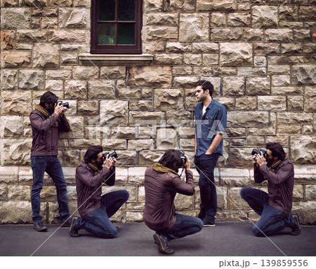 Model, photoshoot and photographer in city with man or paparazzi filming on street for press. Creative, project and person posing for cameraman shooting on wall outdoor with talent and fashion 139859556