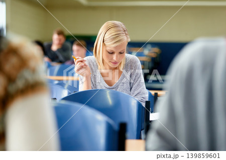 Woman, thinking and exam with pen in classroom for idea, brainstorming and assessment at campus. Female student, planning and sitting with paper for education, knowledge and growth in university Woman, thinking and exam with pen in classroom for idea, brainstorming and assessment at campus. Female student, planning and sitting with paper for education, knowledge and growth in university 139859601