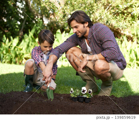 Child, father and support with gardening and flowers in nature for agriculture growth and ecology education. Soil, compost and a man teaching boy kid to plant with spade for organic earth harvest Child, father and support with gardening and flowers in nature for agriculture growth and ecology education. Soil, compost and a man teaching boy kid to plant with spade for organic earth harvest 139859619