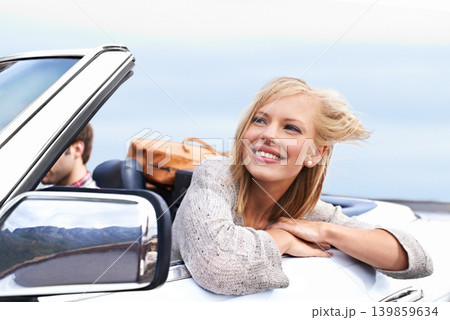 Woman, smile and man driving convertible for travel adventure for vacation, road trip or holiday. Couple, relax and transportation for dating in California for weekend journey, together or bonding 139859634