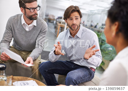 Businessman, documents and meeting with team in discussion for planning, brainstorming or finance at office. Young group of employees with paperwork in budget, strategy or financial plan at workplace 139859637