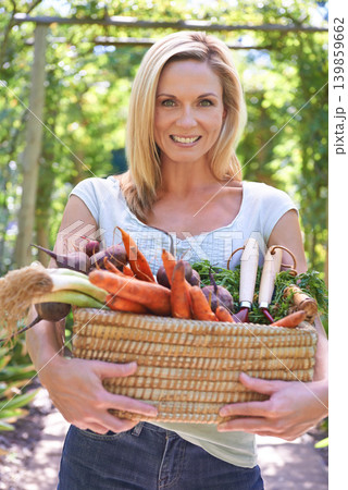 Woman, portrait and basket of vegetables for agriculture harvest for small business, production or sustainability. Female person, face and carrots or beetroot or eco farming career, organic or diet Woman, portrait and basket of vegetables for agriculture harvest for small business, production or sustainability. Female person, face and carrots or beetroot or eco farming career, organic or diet 139859662