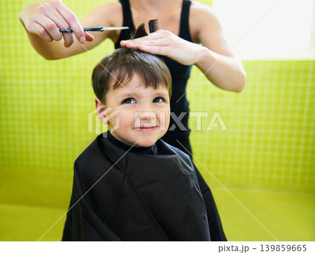 Child, boy and hairdresser with haircut at salon for grooming, hairstyle and grimace with scissors and comb. Barber, person and kid for hair treatment, haircare and hairstyling with cutting and happy 139859665