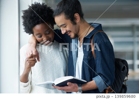 Couple of friends, university and students with a book, education and conversation for research and project. College, man and woman with ideas or brainstorming with planning and teamwork with embrace Couple of friends, university and students with a book, education and conversation for research and project. College, man and woman with ideas or brainstorming with planning and teamwork with embrace 139859680