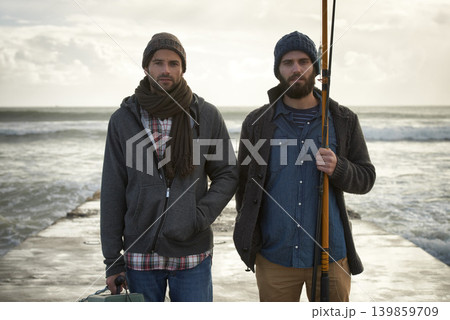 Fisherman, friends and serious with portrait for fishing in the morning by sea with waves, bonding or sky. Friendship, men and face with pride, overcast or rod by water for hobby, holiday or activity 139859709