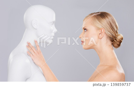 Studio, woman and mannequin with perfect beauty versus fake standard, identity and facial wellness. Girl, doll and face in profile for cosmetics, plastic surgery or makeup on grey background. Studio, woman and mannequin with perfect beauty versus fake standard, identity and facial wellness. Girl, doll and face in profile for cosmetics, plastic surgery or makeup on grey background. 139859737
