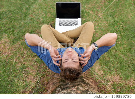 Man, headphones and music in park with laptop streaming podcast or radio under tree outdoor. Person, aerial view and listening to sound on grass or relax with calm audio for work in woods or backyard 139859780