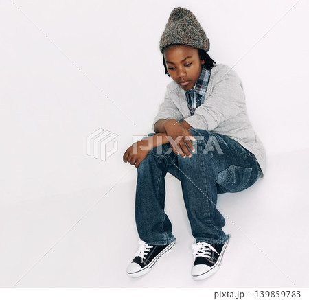 Child, sad and fashion with problem and frustrated with depression in a studio. Youth, annoyed and bored African male boy with casual fashion and gen z clothes sitting with white background and issue Child, sad and fashion with problem and frustrated with depression in a studio. Youth, annoyed and bored African male boy with casual fashion and gen z clothes sitting with white background and issue 139859783