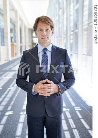 Serious, office and portrait of business man in hallway for growth, pride and confident mindset for company. Corporate manager, professional and person in workplace for career, job and opportunity Serious, office and portrait of business man in hallway for growth, pride and confident mindset for company. Corporate manager, professional and person in workplace for career, job and opportunity 139859801