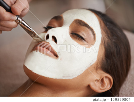 Skincare, brush and woman with face mask at spa for glow, wellness and beauty routine with self care. Cosmetic, natural and female person relaxing for clay facial dermatology treatment at salon. 139859804