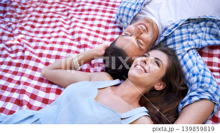 Couple, happy and relax on blanket for picnic in top view for bonding, love and connection on date. Man, woman and laying on ground together for romance, vacation or outdoor in healthy relationship Couple, happy and relax on blanket for picnic in top view for bonding, love and connection on date. Man, woman and laying on ground together for romance, vacation or outdoor in healthy relationship 139859819