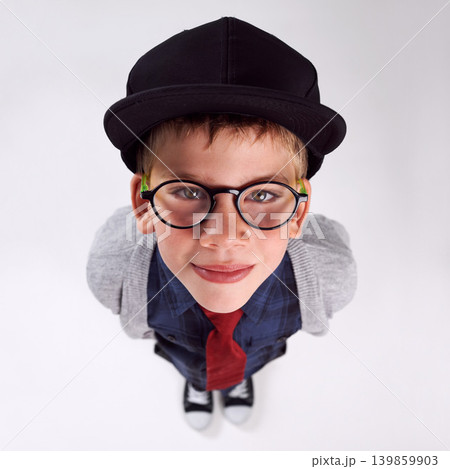 Glasses, happy and portrait of child in studio for eye care, vision and optical health. Smile, optometry and top view of young boy kid with stylish eyewear or spectacles isolated by gray background. Glasses, happy and portrait of child in studio for eye care, vision and optical health. Smile, optometry and top view of young boy kid with stylish eyewear or spectacles isolated by gray background. 139859903