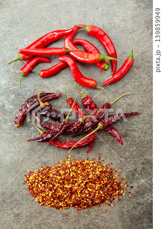 Red hot chili peppers on a stone background. Red hot chili peppers on a stone background. 139859949