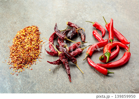 Red hot chili peppers on a stone background. Red hot chili peppers on a stone background. 139859950