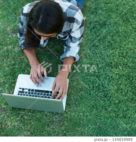 Above, grass and person typing on laptop in park with college research, project or learning on campus. University, student and girl reading online with ebook, education and study on lawn in garden Above, grass and person typing on laptop in park with college research, project or learning on campus. University, student and girl reading online with ebook, education and study on lawn in garden 139859989