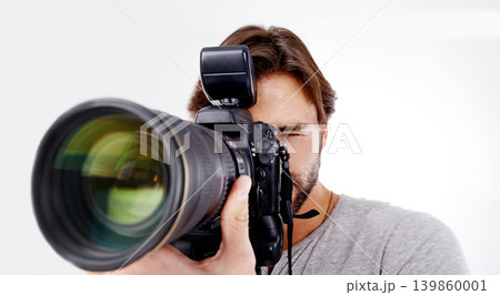 Man, camera lens and photographer with technology in studio, press or media for news on white background. Photography, photo journalist and creative with paparazzi, equipment and closeup in studio 139860001