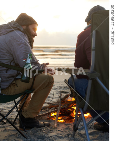 Beach, beer and fire with man friends talking on coast or shore from back for travel, holiday or vacation. Nature, camping and sunset with happy young people together on sand by sea or ocean Beach, beer and fire with man friends talking on coast or shore from back for travel, holiday or vacation. Nature, camping and sunset with happy young people together on sand by sea or ocean 139860200